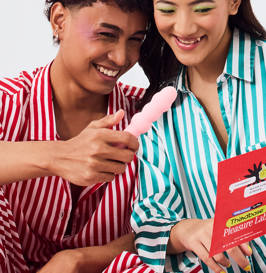A couple smiling and holding a Vibrator by Thirdbase