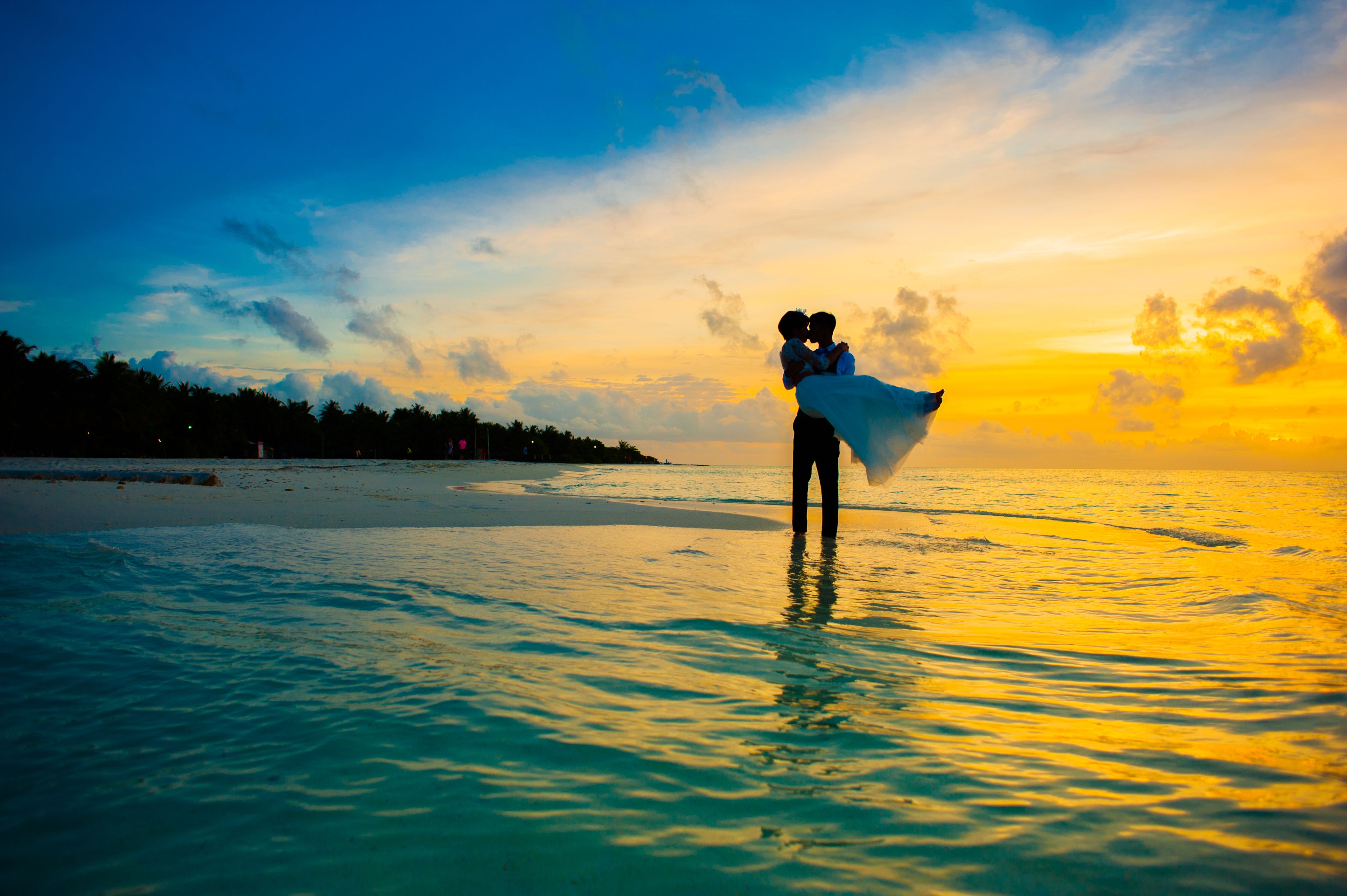 Indian couple on honeymoon with sunset in the background