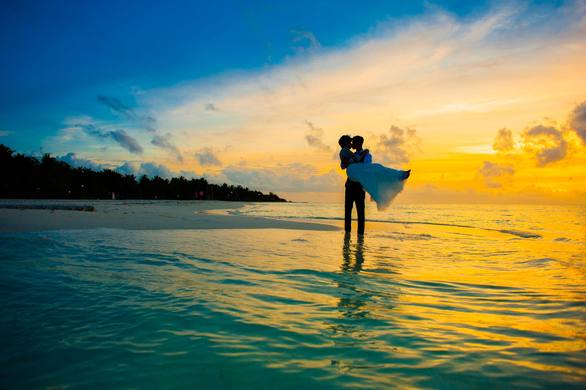 Indian couple on honeymoon with sunset in the background