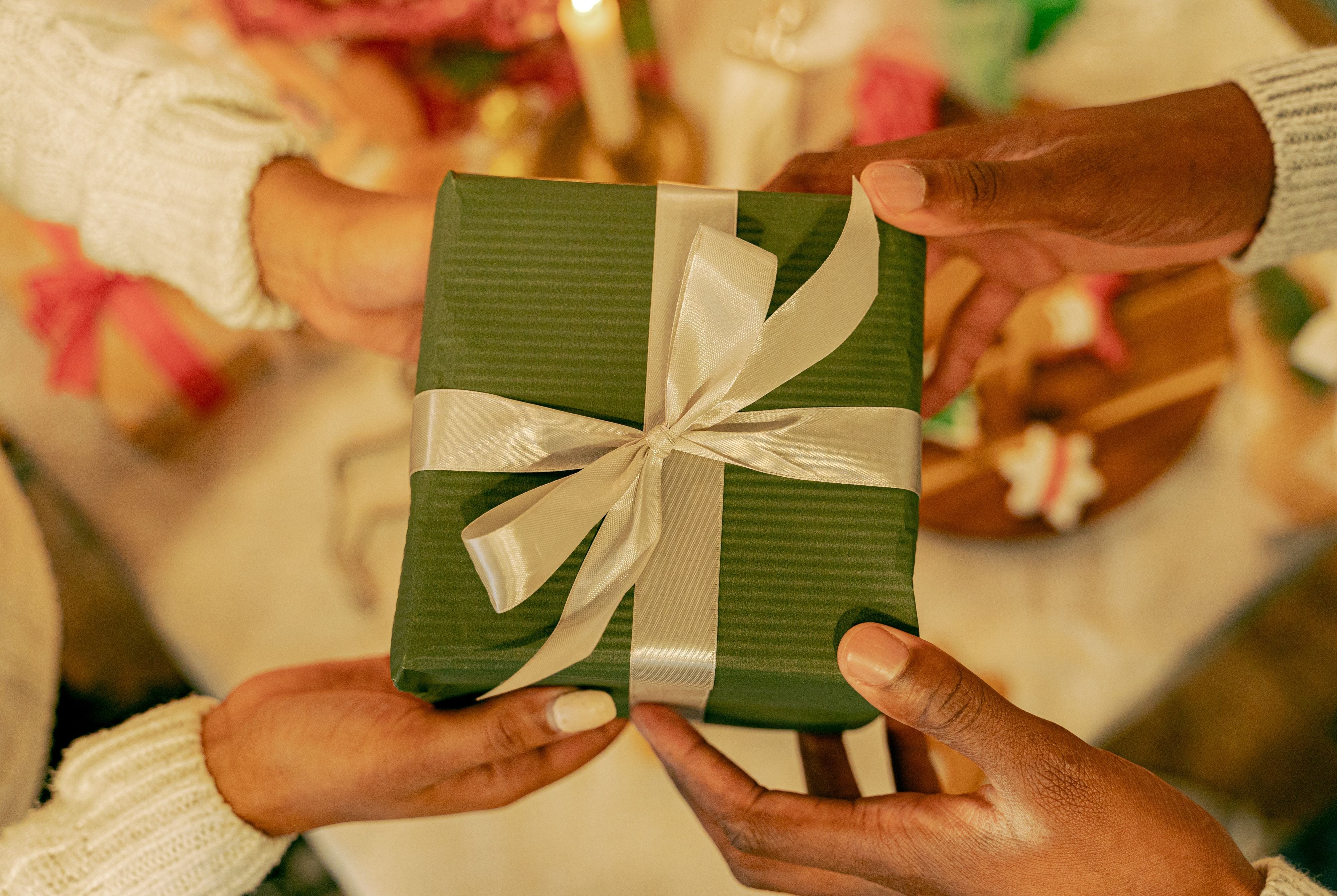 A plainly wrapped gift box being handed over